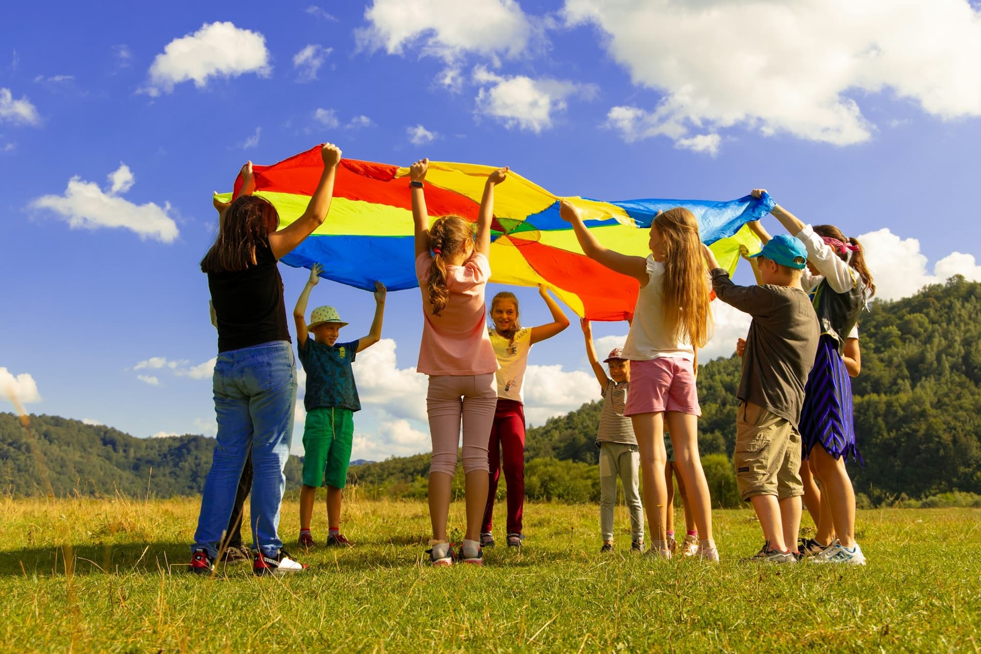 Kinderen spelen met een kleurrijk parachutedoek